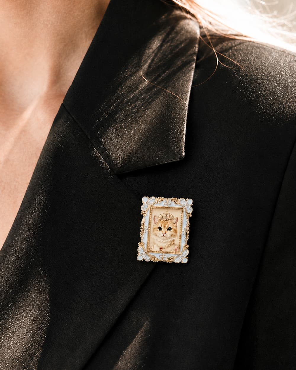 Square Royal custom cat portrait brooch worn on a black blazer lapel.