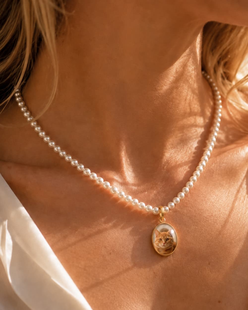 Close-up of a custom pet photo necklace portrait pendant.