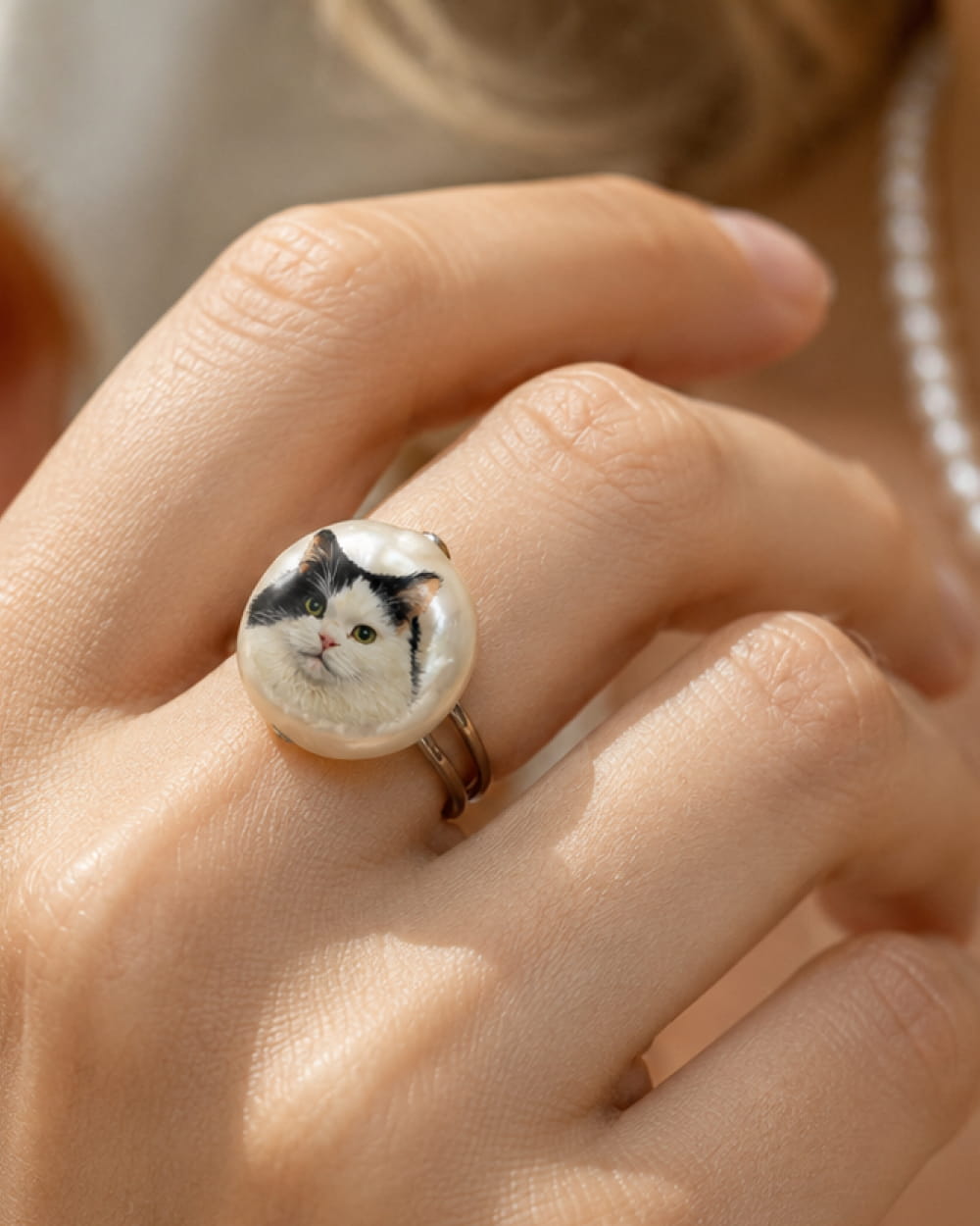 Model wearing custom cat portrait pearl ring
