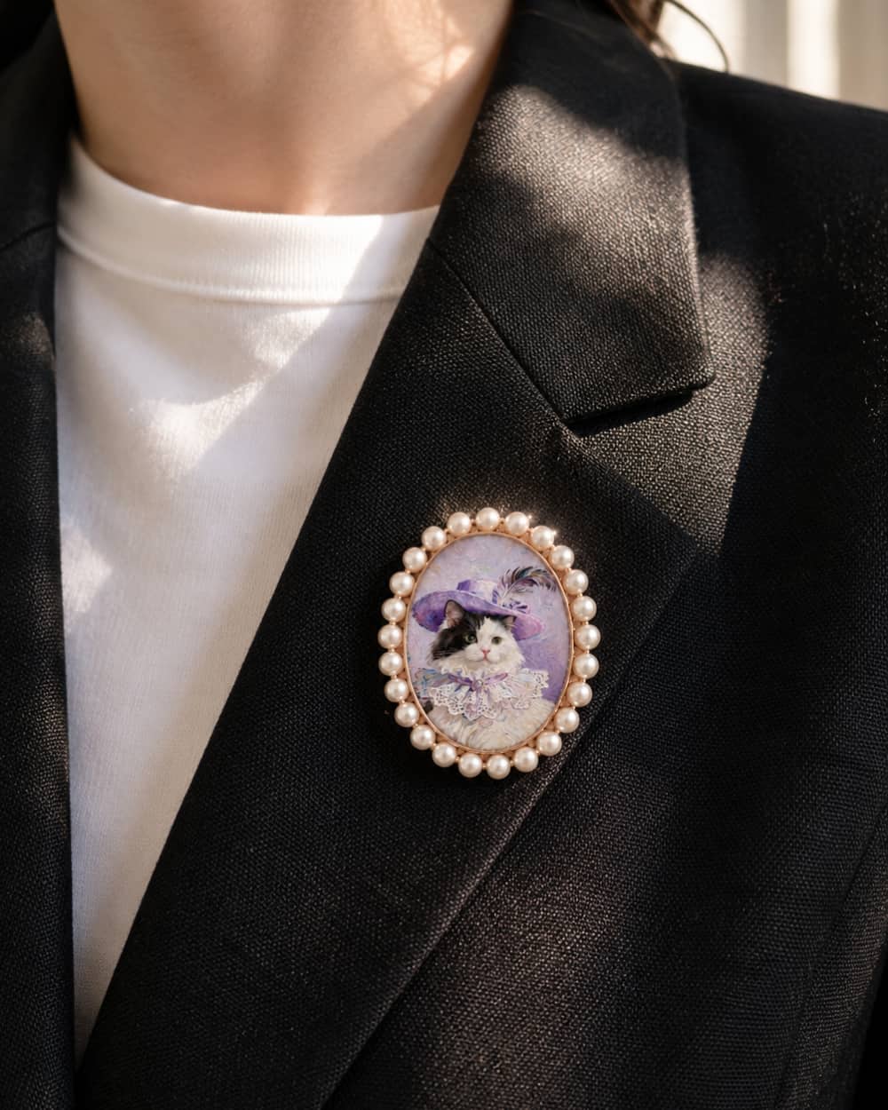 Pearl Frame custom pet portrait brooch worn on a black blazer.