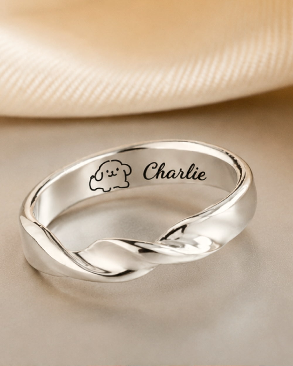 Custom dog memorial ring engraved with Charlie in handmade 999 fine silver.