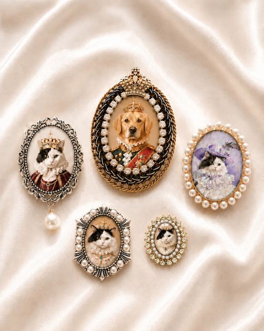 Five custom pet portrait brooch designs on ivory satin, including the Aurora Brooch with a crystal and pearl halo.