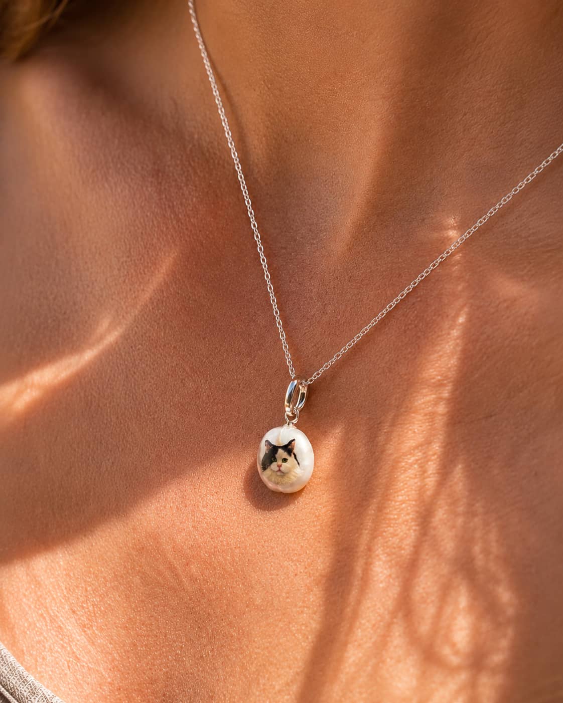 Model wearing personalized cat portrait pearl necklace