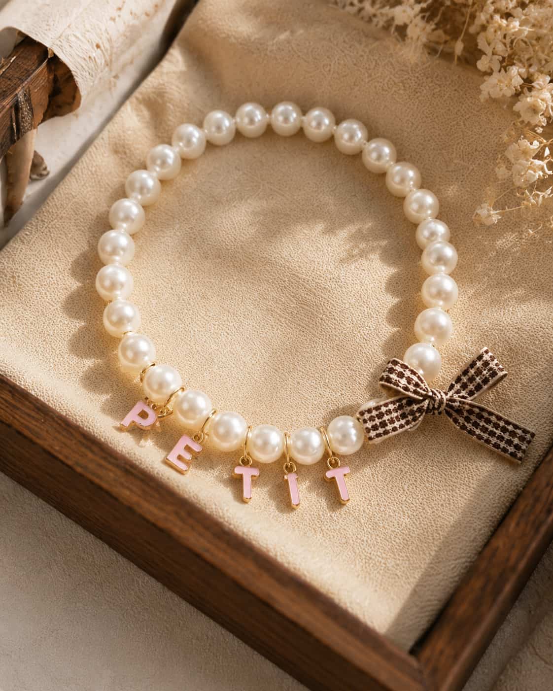 Custom faux pearl pet name collar flat lay product photo