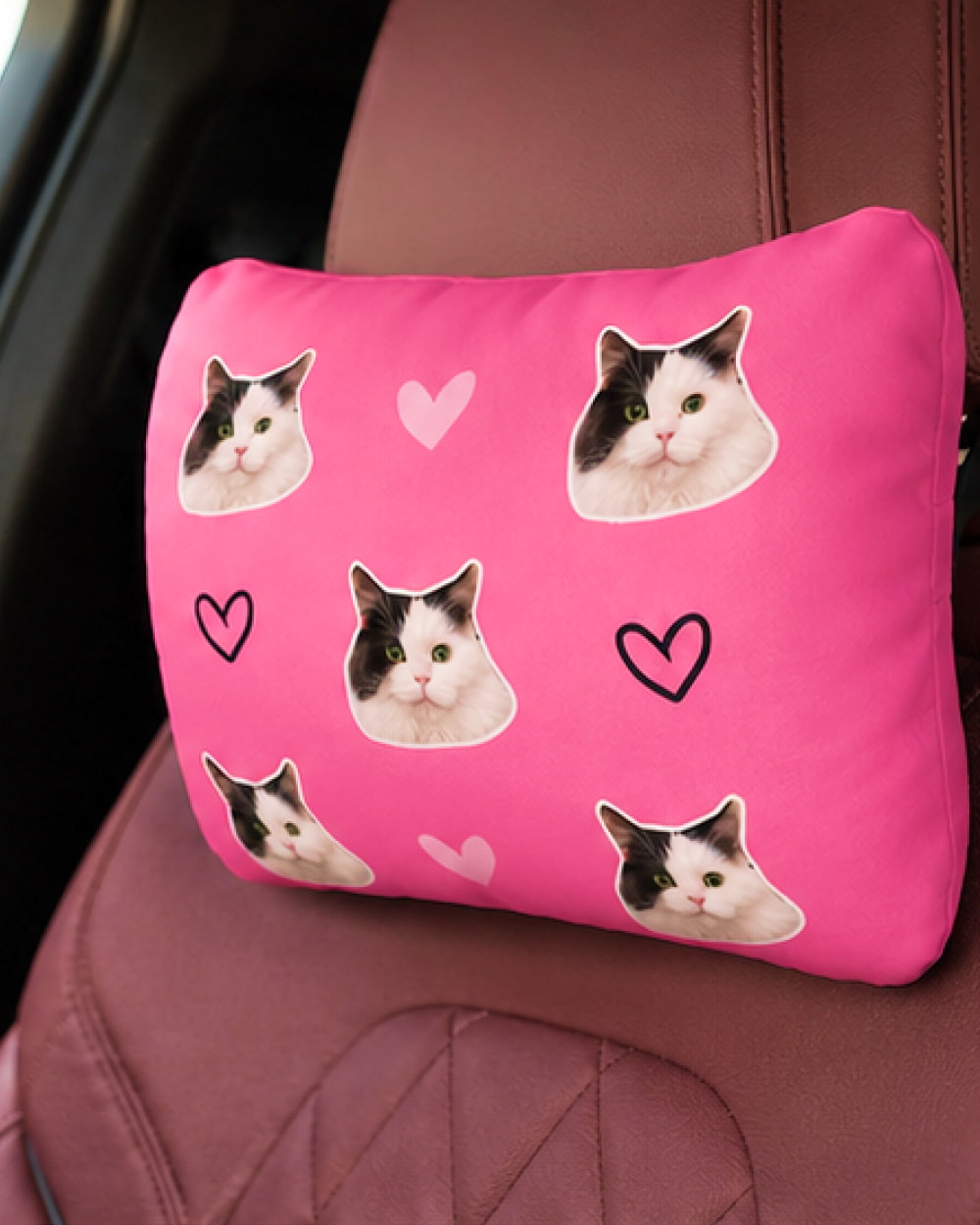 Personalized pink car headrest pillow with custom pet portrait design.