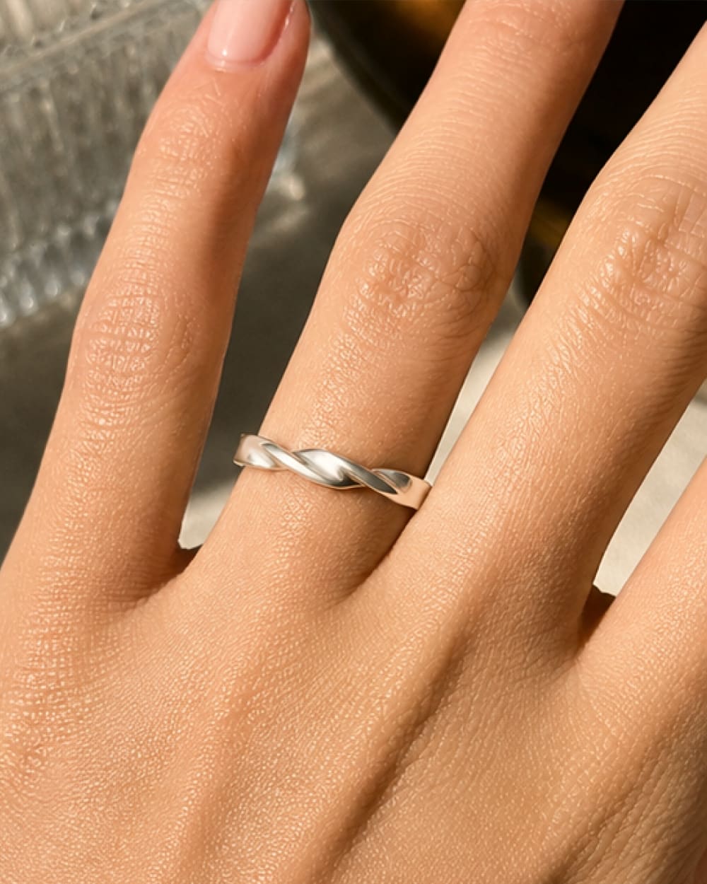 Personalized pet memorial Mobius ring worn on finger.