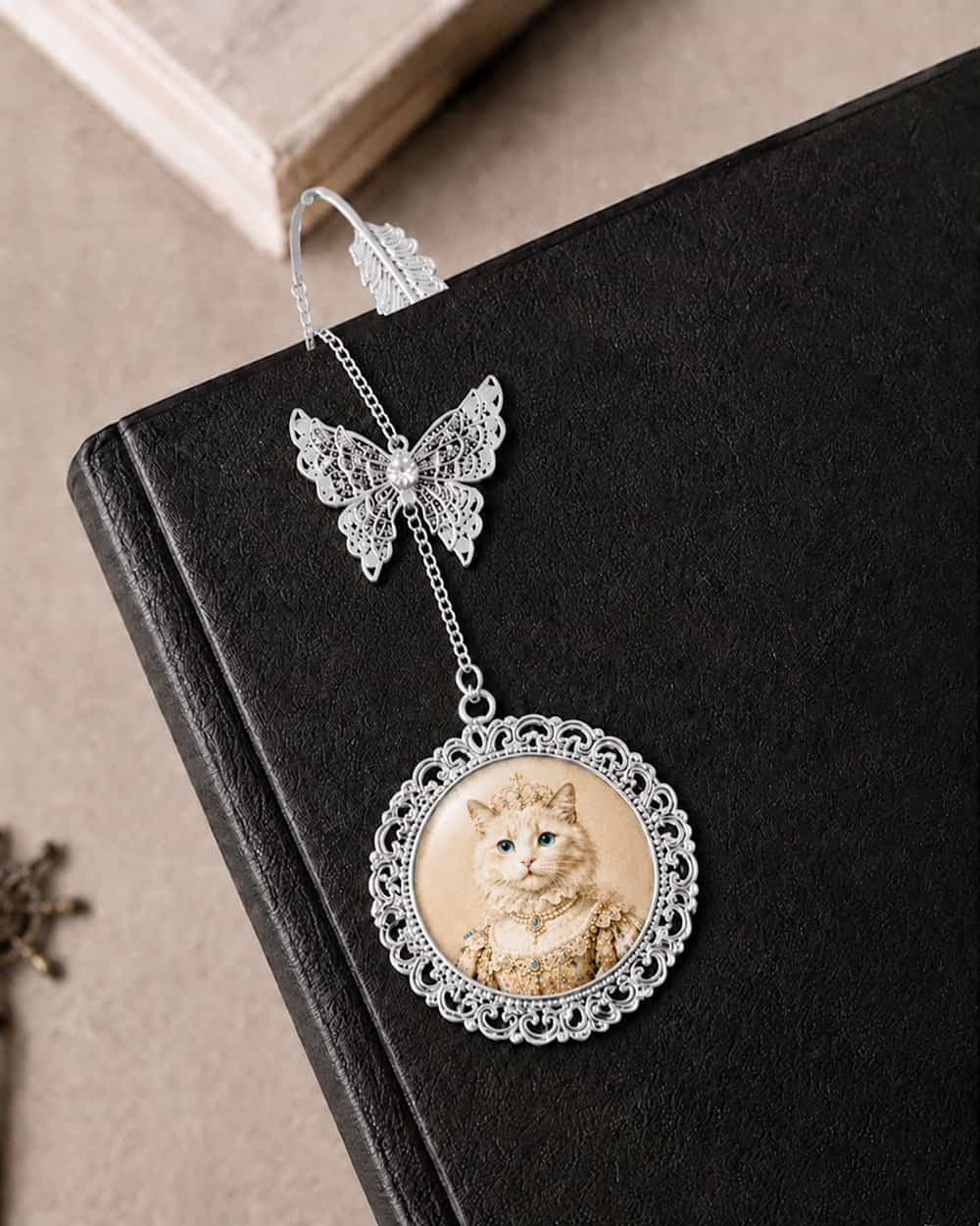 Silver personalized pet portrait bookmark placed in a book, custom made from a pet photo.