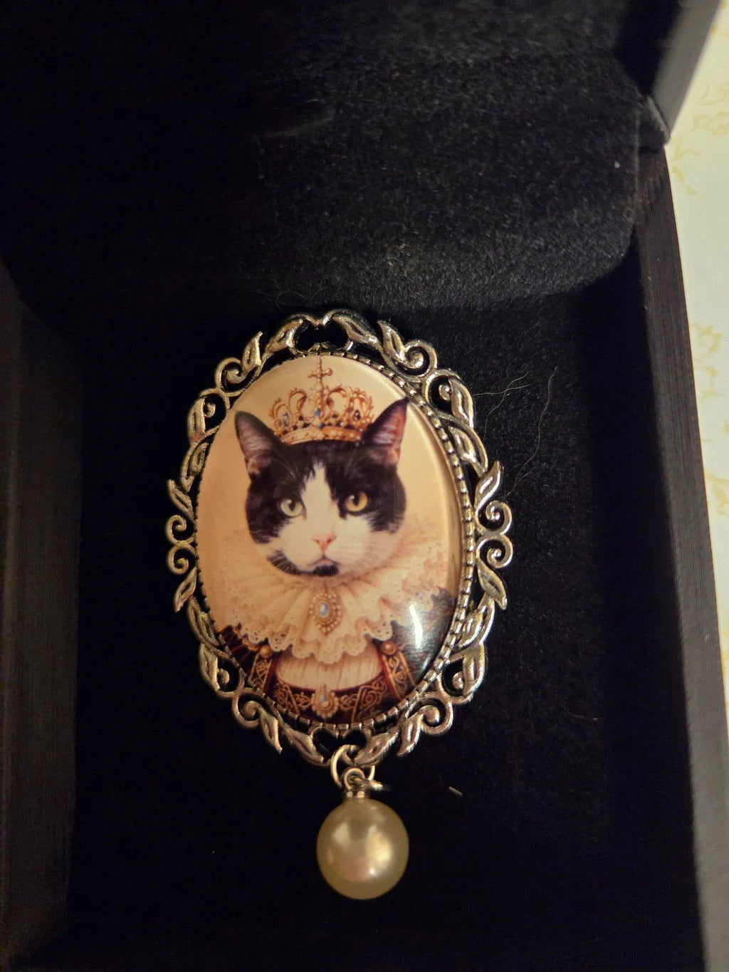 Finished vintage-frame brooch with a black-and-white cat portrait